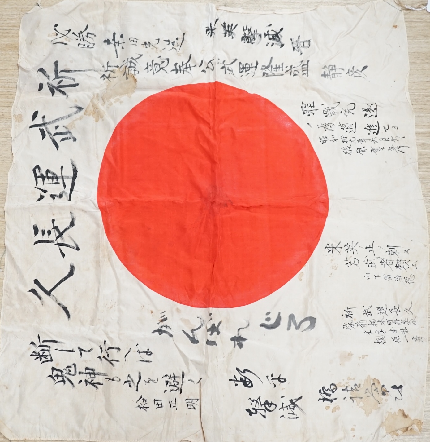 A WWII Japanese signed silk prayer flag, 83 x 73cm. Condition - fair, significant staining in some areas